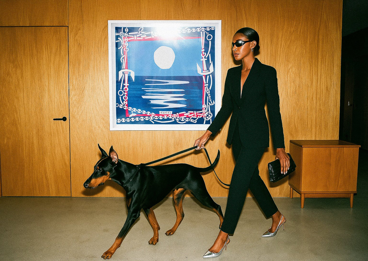 Gucci nautical silk scarf framed as luxury wall art, styled in a modern interior with model and Doberman, fashion-meets-interiors campaign