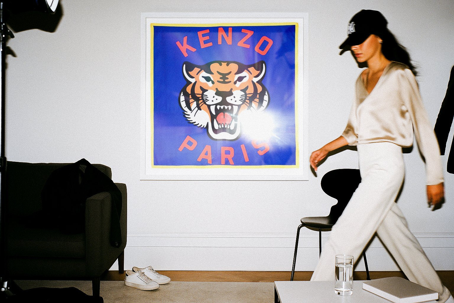 Kenzo tiger silk scarf framed as statement wall art in a modern interior, fashion-inspired home styling with model in satin blouse